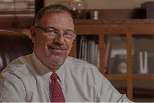 A man in glasses and a red tie.
