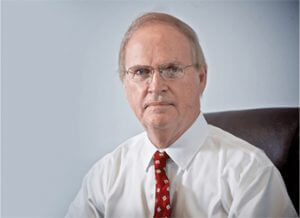 A man in a white shirt and red tie.