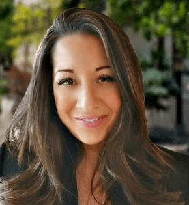 A woman with long hair and a smile.
