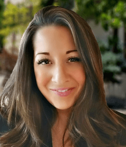 A woman with long hair and a smile.