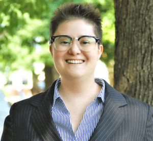 A woman with glasses and a jacket on.