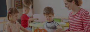 A young boy playing with an orange toy.