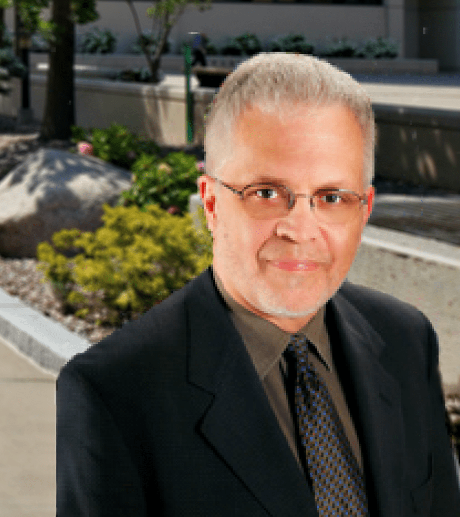 A man in a suit and tie standing outside.