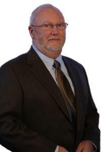 A man in a suit and tie standing up.