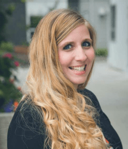 A woman with long blonde hair smiling for the camera.