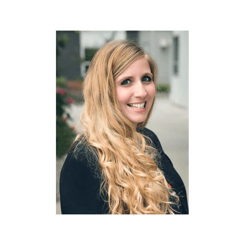 A woman with long blonde hair standing outside.