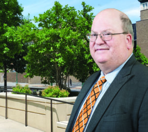 A man in a suit and tie standing outside.
