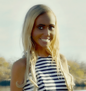 A woman with blonde hair and wearing a striped shirt.