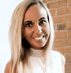 A woman with blonde hair and white shirt smiling.