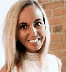 A woman with blonde hair and white shirt smiling.