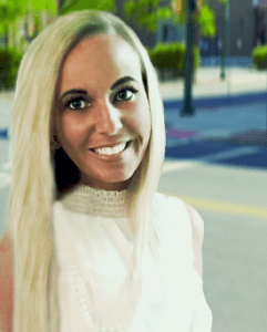 A woman with long blonde hair smiling for the camera.