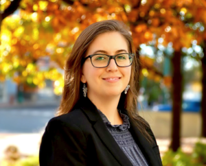 A woman in glasses and a black jacket