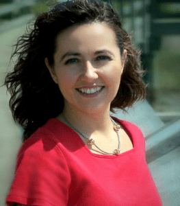 A woman in red shirt smiling for the camera.