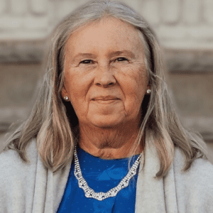 A woman with long hair and a blue shirt