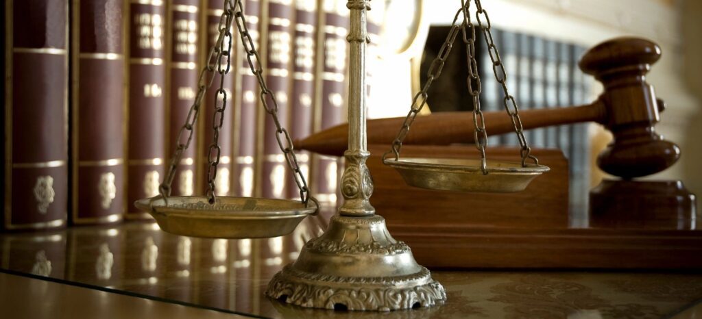A close up of the scales of justice on top of a table